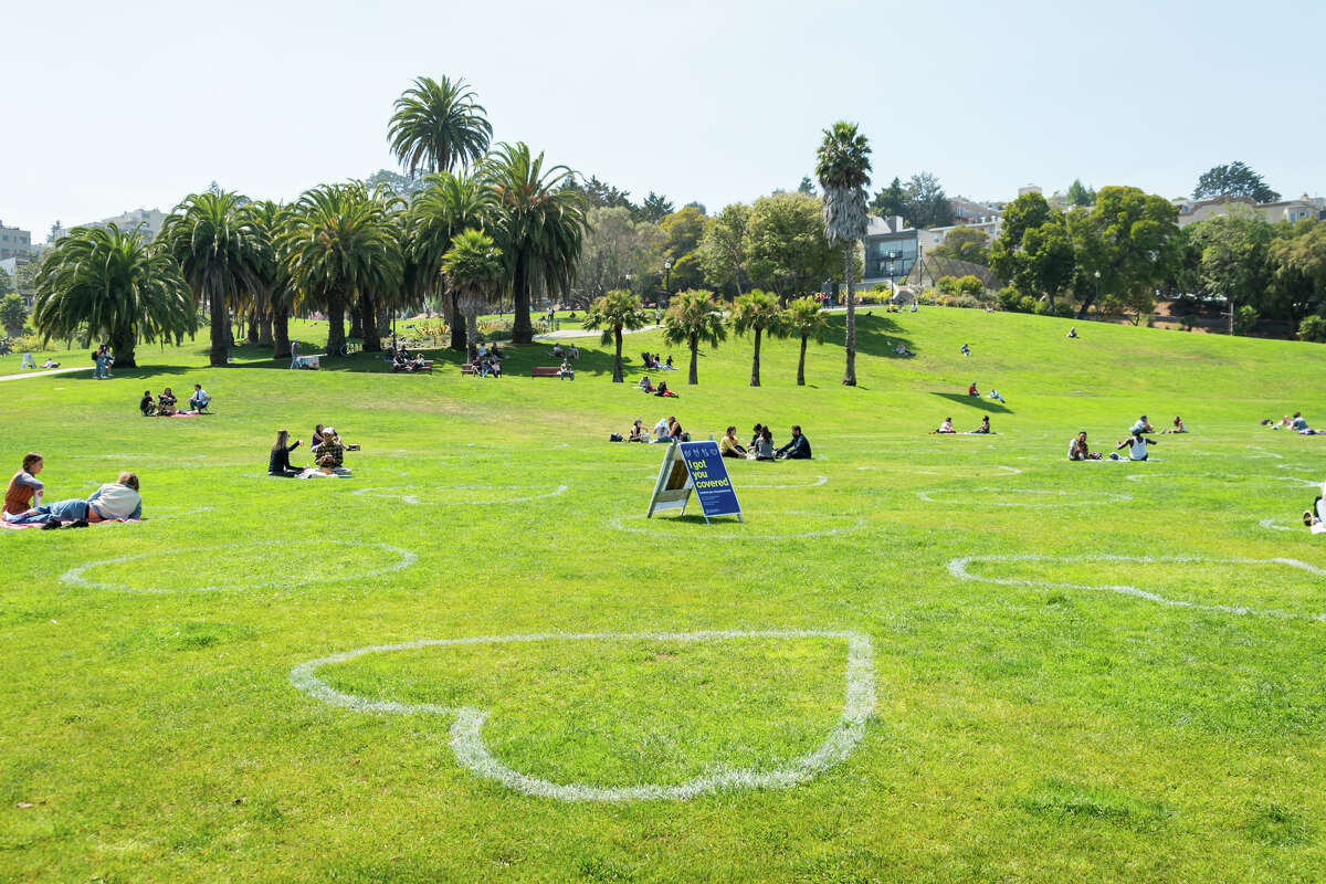 People enjoy the warm weather in socially distanced circles at Dolores Park in San Francisco, California on Sept. 4, 2020.