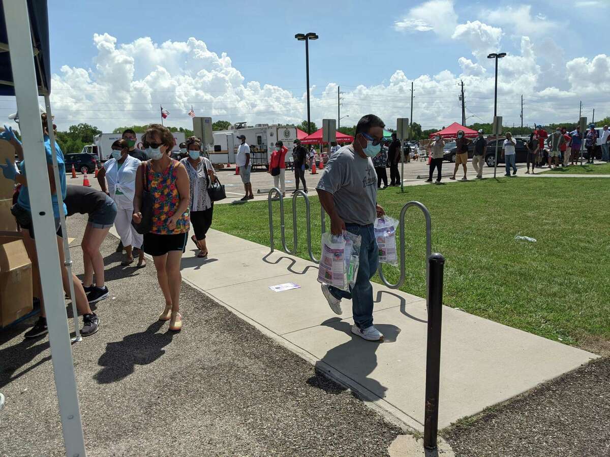 Residents line up for their personal protection equipment kit giveaway on Friday at Fort Bend County’s Four Corners Recreation Center in Sugar Land.