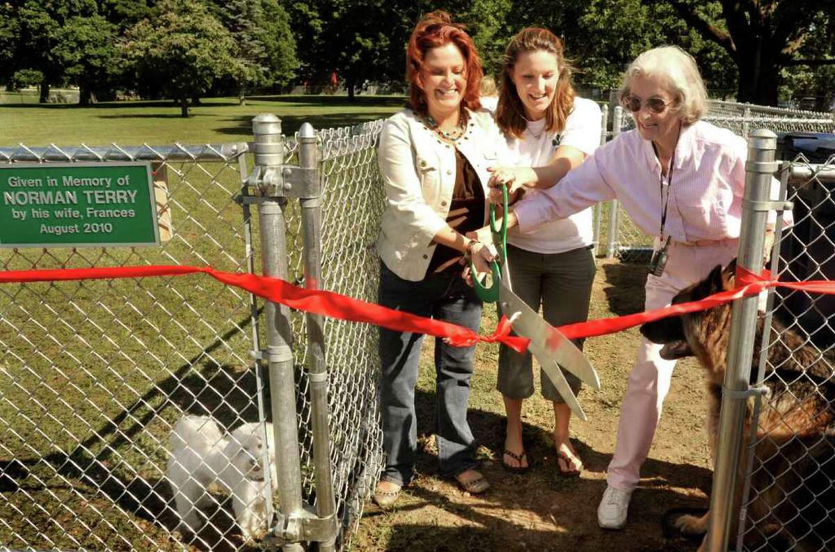 Tammy Reardon, left, Lori Sartwell, center, and Frances Terry, cut the ribbon at the opening the New Milford Dog Park, Saturday, Aug. 28, 2010.