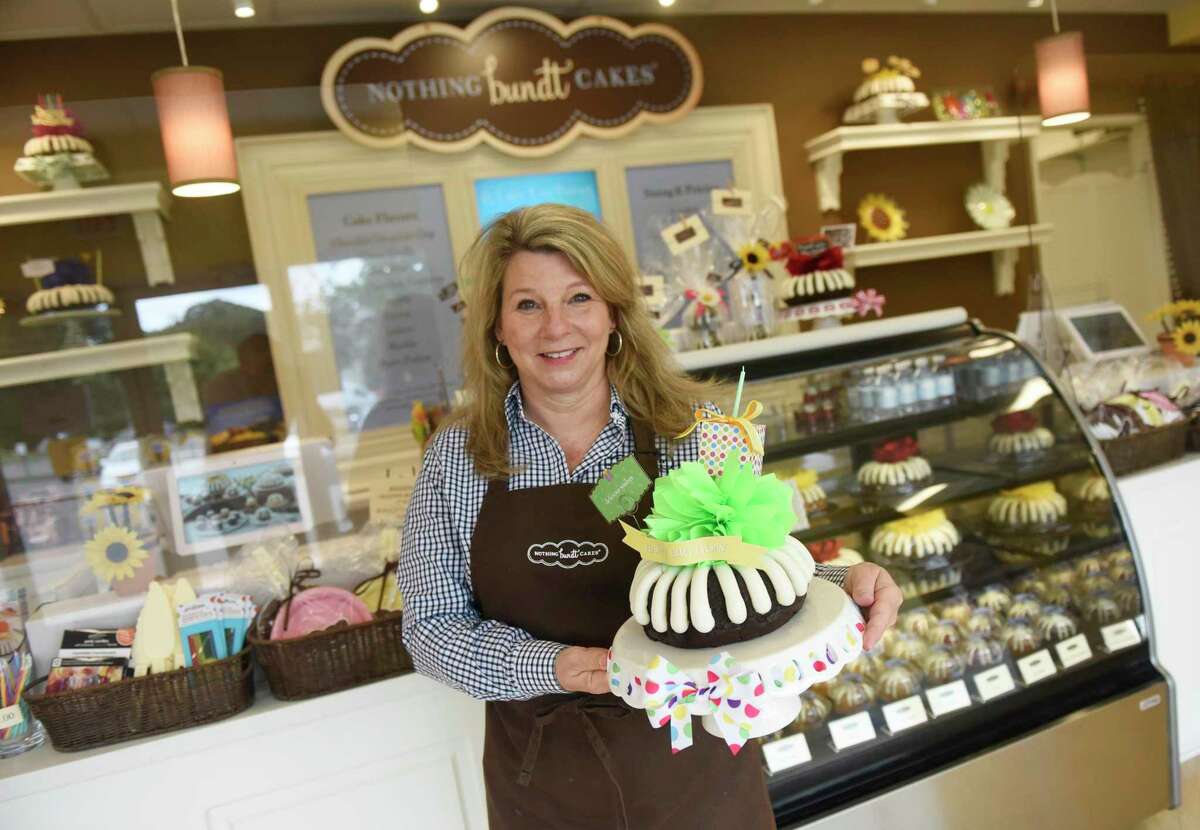 Store owner Ann Folger shows a birthday bundt cake at Nothing Bundt Cakes in Stamford, Conn. Tuesday, Sept. 1, 2020. Nothing Bundt Cakes has more than 300 bakeries throughout the U.S., but the Stamford location is the first in Connecticut. The punny niche bakery features bundt cakes of all sizes and flavors for all occassions.