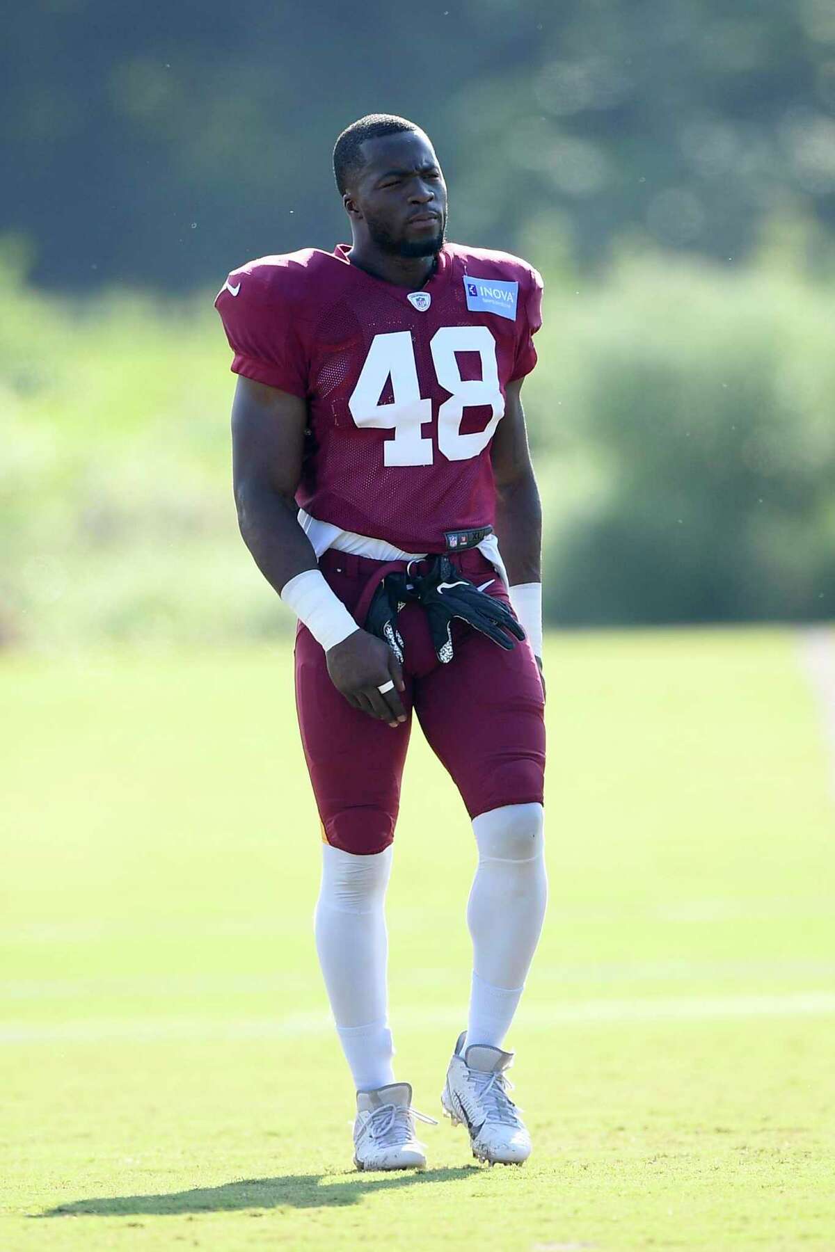 Washington linebacker Kevin Pierre-Louis stands on the field during practice at the team’s training facility.