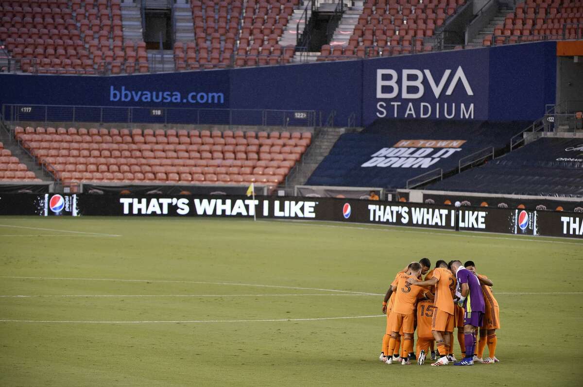 Houston Dynamo players gather before an MLS soccer match against Sporting Kansas City, Saturday, Sept. 5, 2020, in Houston.