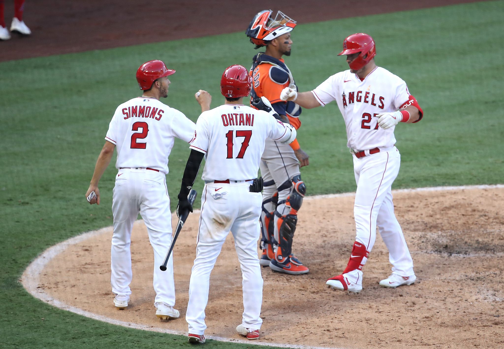 Los Angeles Angels center fielder Mike Trout #27 is greeted at