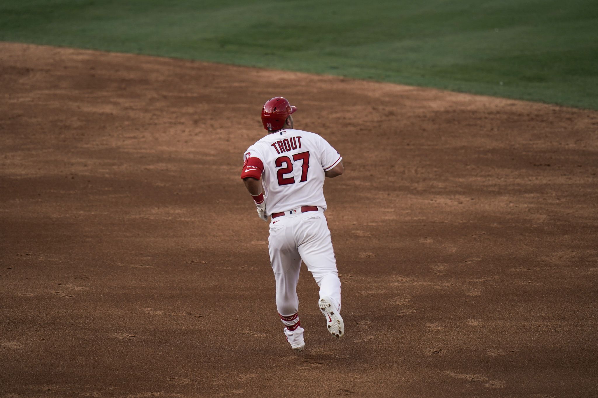 Los Angeles Angels center fielder Mike Trout #27 is greeted at