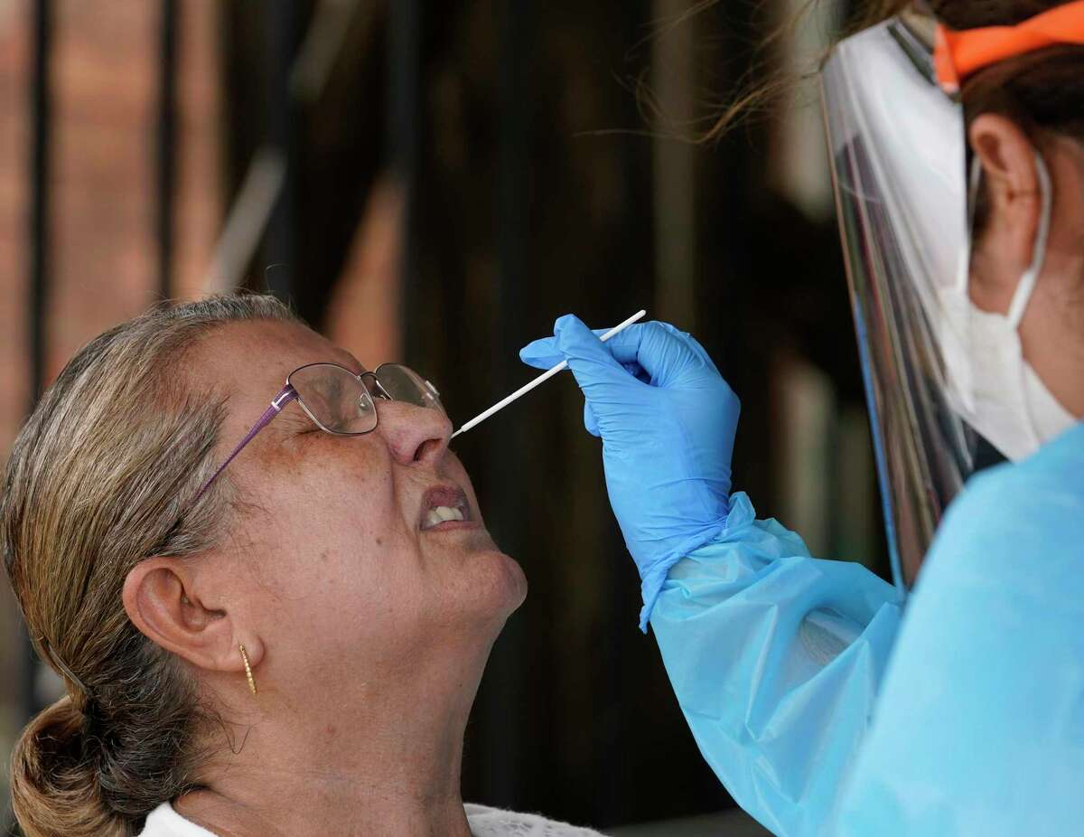 Teresa de Rojas, left, has a swab taken by Anne Aguilar, right, a medical student, at a free COVID-19 testing site conducted by United Memorial Medical Center at the Consulate General Of Mexico, 4506 Caroline St., Sunday, June 28, 2020, in Houston.