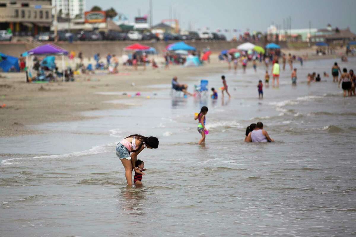People gather to enjoy the beach at the Galveston Seawall on Labor Day weekend Saturday, Sept. 5, 2020, in Galveston.