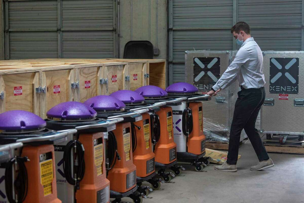 Nick Ward, Xenex materials manager, demonstrates Wednesday, Sept. 2, 2020 how the company's LightStrike xenon-light-emitting disinfecting robots are prepared for shipping to customers.