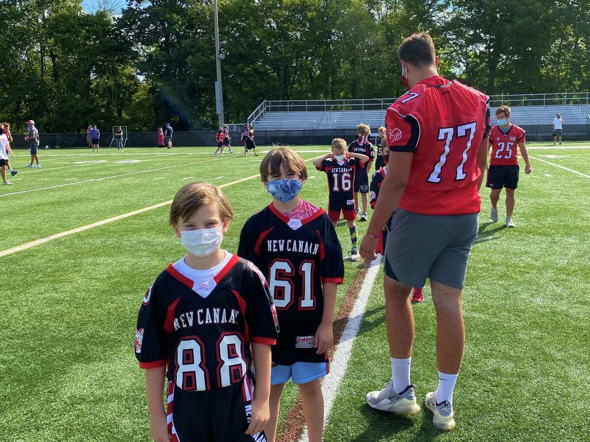 ‘Let us play!’: New Canaan football community comes out to support high