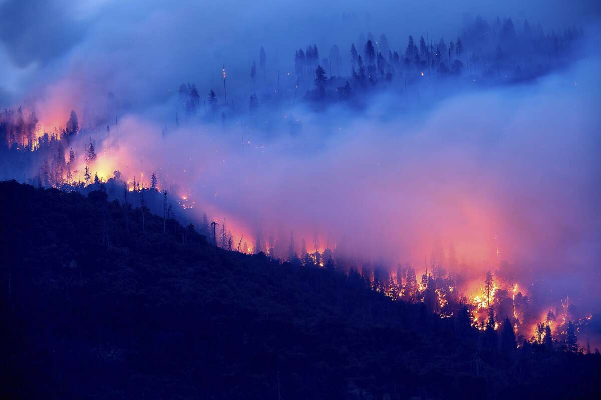 The Creek Fire burns along a hillside in the Cascadel Woods community of Madera County, Calif., on Monday, Sept. 7, 2020. (AP Photo/Noah Berger)