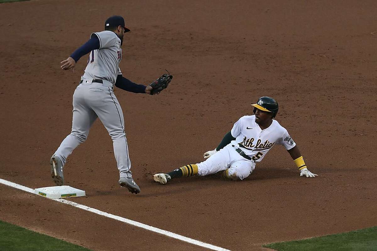 Oakland Athletics' Tony Kemp is tagged out on a steal attempt as the Houston Astros' Abraham Toro applies the tag during the second inning of a baseball game in Oakland, Calif., Monday, Sept. 7, 2020. (AP Photo/Jed Jacobsohn)