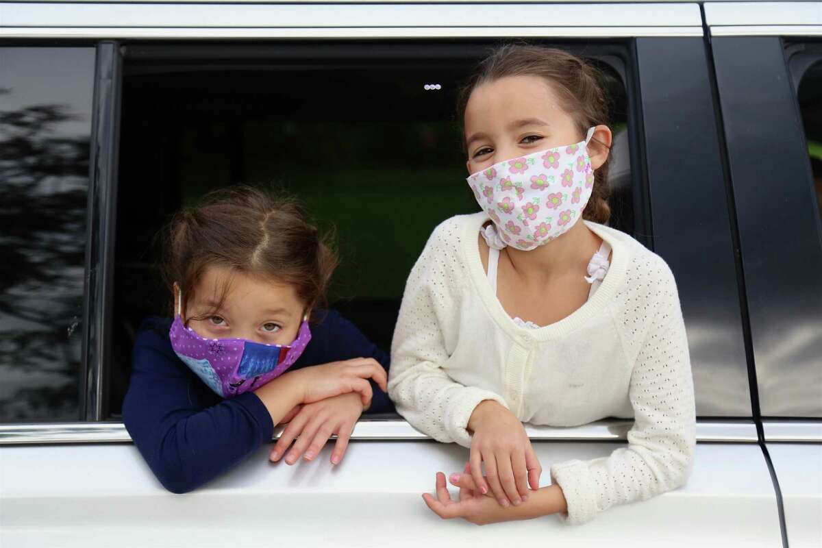 Twins Aurora, left, and Winnie Gulati, 6, are glad to be heading back to second grade at Miller-Driscoll on Sept. 8, 2020, in Wilton, Conn.