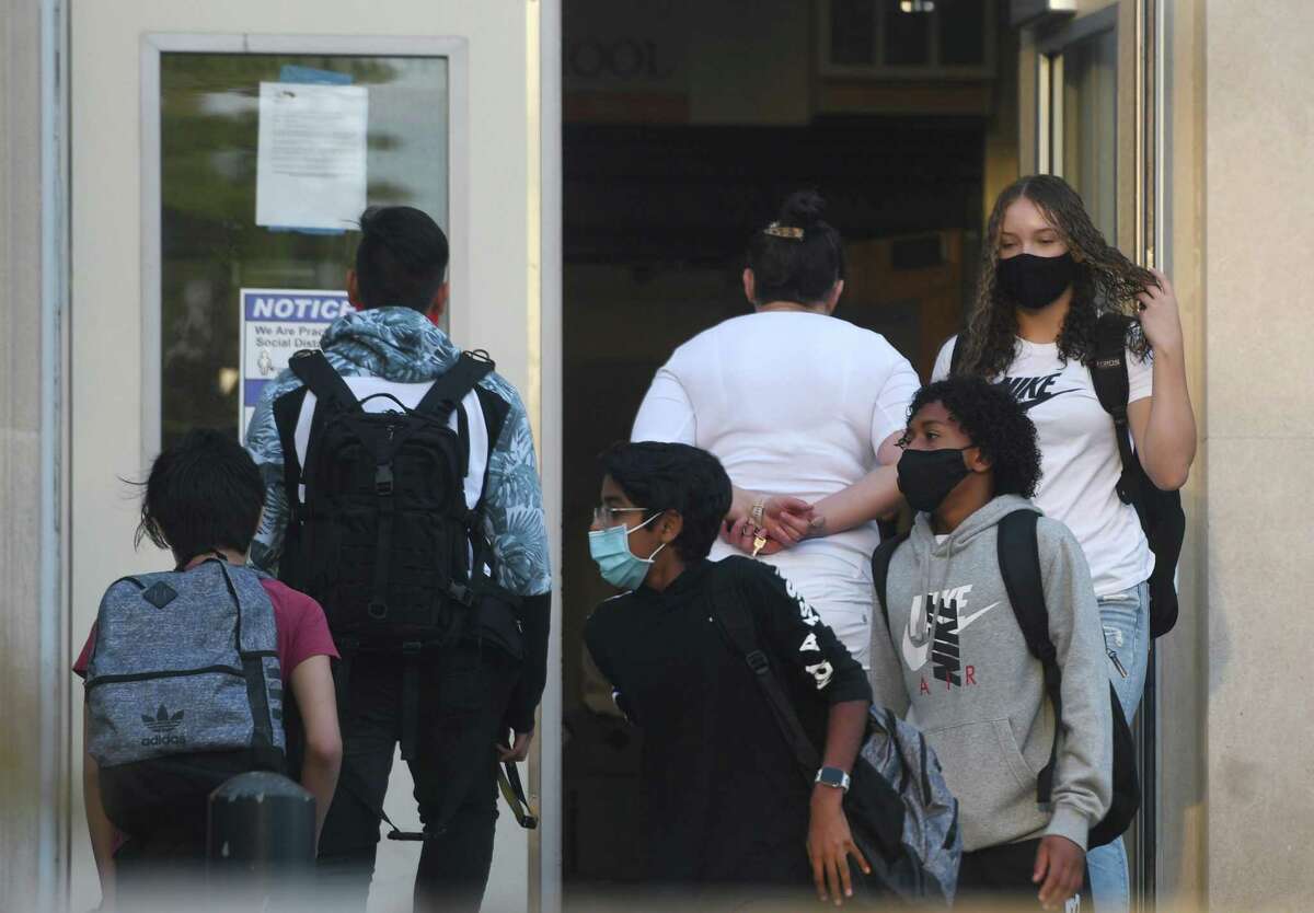 Students enter school on the first day of the 2020-21 school year at Stamford High School on Tuesday. As a coronavirus precaution, students will be split into two groups to attend classes every other day. On days when they are not physically in class, students will learn remotely.