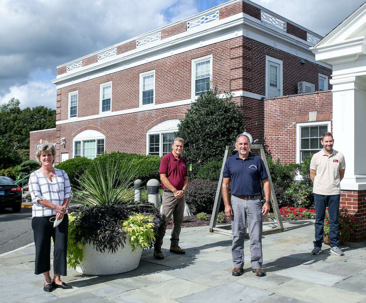 Julia Gabriele, associate head of school & chief financial officer; Rich Kaechele, facilities technician; John Tita, facilities technician; and Mike Mitchell, designLab director in front of the newly installed parapets at St. Luke’s School in New Canaan.