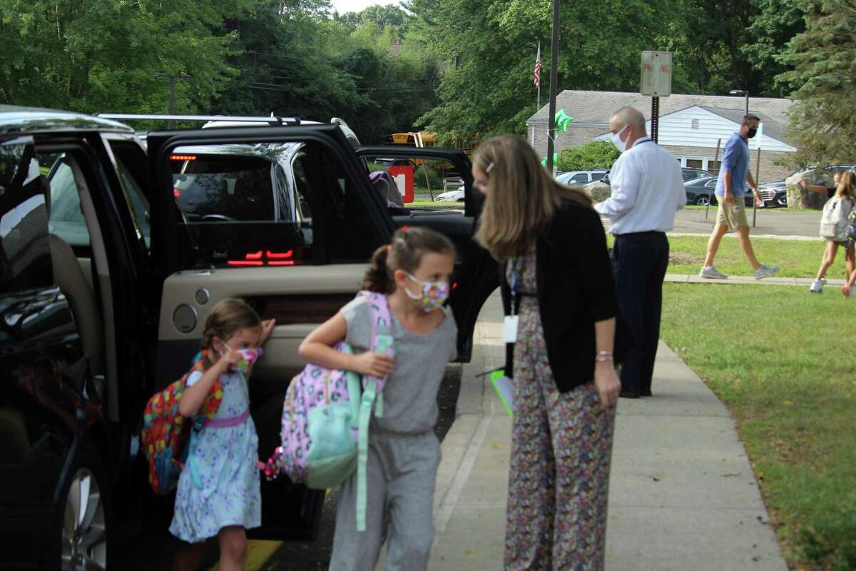 Coleytown Elementary School principal Janna Sirowich helped welcome students on their first day back at school. Taken Sept. 8, 2020 in Westport, Conn. Students stepped off buses and out of cars with their back packs and a colorful assortment of masks for their first day back. Several teachers and administrators shared their joy with families as they welcomed everybody outside the school. "We are so excited for this," Janna Sirowich, principal of Coleytown Elementary School, said. "No one becomes an educator to work at home without seeing children. We are so thrilled to welcome everyone back." Sirowich said staff has spent the past two weeks discussing student engagement, health and safety protocols and building relationships.