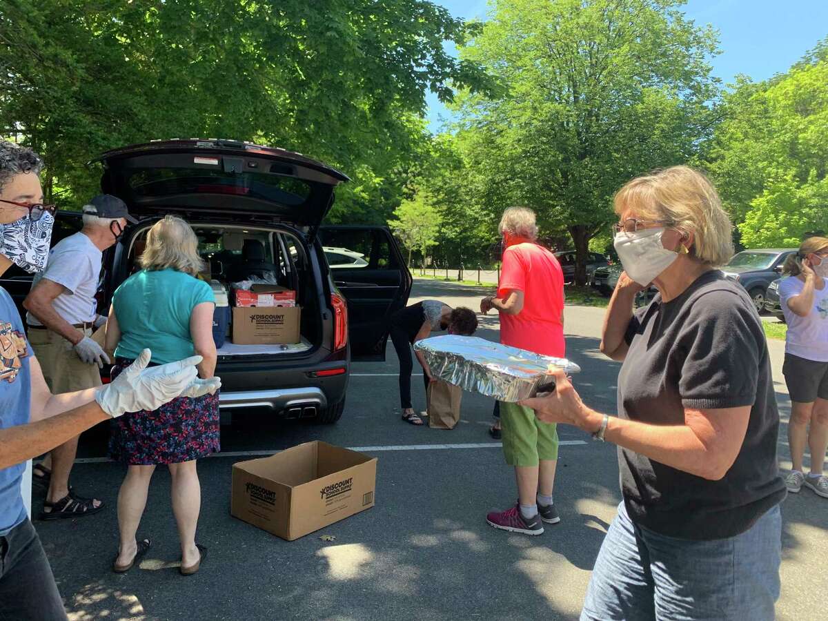 FCC volunteers collecting homemade dishes for the Pot Luck For Pivot.
