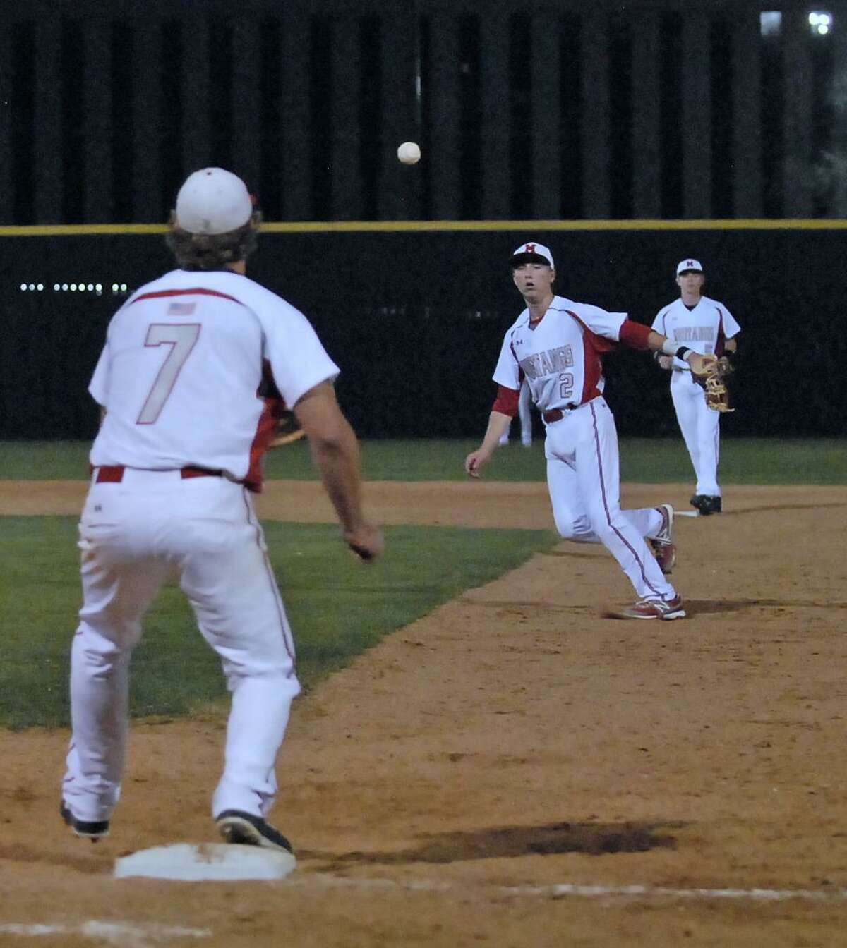 Memorial's Tyler McCloskey (#7) covers first base as Kody Clemens (#2) fields a Stratford hit and throws to first for the force out during their game at Memorial High School Tuesday 2/26/13. Standing on second base is Reid Nagle (#5). Photo © by Tony Bullard.