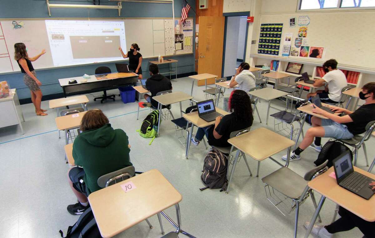 Teacher Lauren Marchello, left, teaches Modern Global Studies during the first day of school at Fairfield Ludlowe High School in Fairfield, Conn., on Tuesday Sept. 8, 2020. Also working with Marchello is secondary teacher Aaryn Signorile.