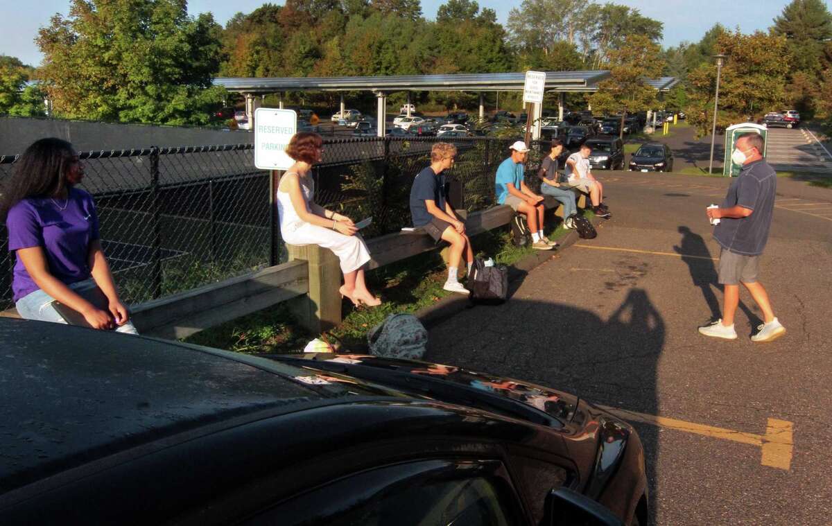 Teacher Sean Patrick, right, teaches Social Studies outside during the first day of school at Fairfield Ludlowe High School in Fairfield, Conn., on Tuesday Sept. 8, 2020.