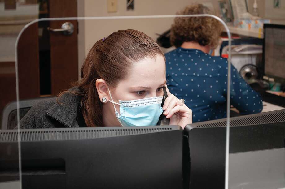 Julia Gound works with patients over the phone while working with Lisa Farmer (back) at the Springfield Clinic Urgent Care on Morton Avenue. The clilnic is undergoing renovations. Photo: Darren Iozia | Journal-Courier / Jacksonville Journal-Courier