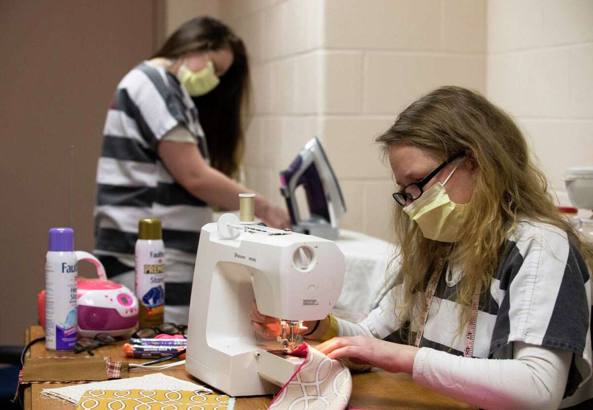 Fort Bend County Jail inmates Samantha Runke, left, and Andrea Pesce make cloth masks Thursday, April 9, 2020, in Richmond, Texas. The Fort Bend County Detention's sewing program are making the face masks to be distributed to all inmates and jail employees as a precaution against the spread of the coronavirus.