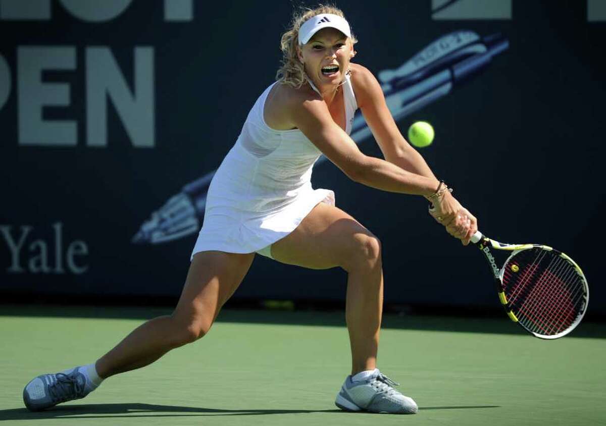 Caroline Wozniacki returns the ball to Nadia Petrova during the women's final Saturday August 28, 2010 at the Pilot Pen Tennis Tournament in New Haven.