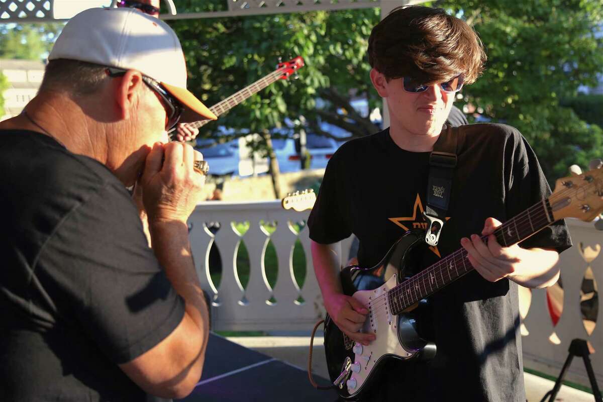 Band mates Nick Giaquinto, left, and Jack Good of Simple Jim share a jam at the KJD fundraiser concert on Sherman Green on Saturday, Sept. 5, 2020, in Fairfield, Conn. Simple Jim performed a selection of hard-hitting rock songs, which reverberated across downtown and had the crowd smiling. “We just wanted to keep it safe with being outdoors,” said Chris Coppola, drummer for the group.