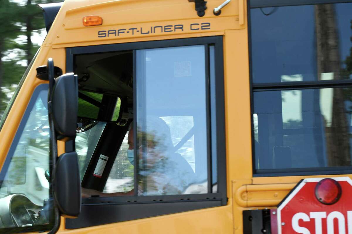 A masked Bethlehem Central School District bus driver transports Bethlehem Middle School students following a school orientation session on Wednesday, Sept. 9, 2020, on Kenwood Avenue in Delmar, N.Y. Bethlehem Central School District students are beginning to return to the classroom under coronavirus safety guidelines. (Will Waldron/Times Union)