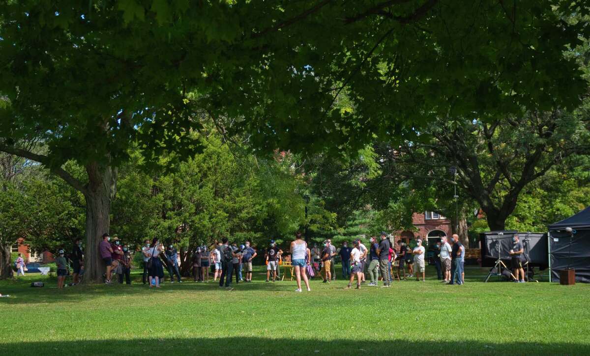 Crew and cast members of the television show Modern Love gather for a meeting as they prepare to film a scene at Washington Park on Wednesday, Sept. 9, 2020, in Albany, N.Y. (Paul Buckowski/Times Union)