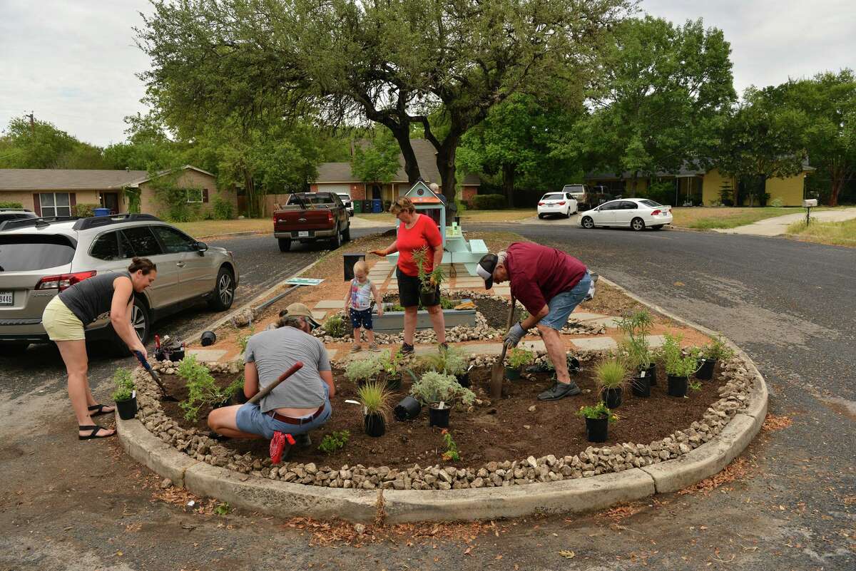 Volunteers work on the small, neighborhood park they’ve created in the Fairfield on the North Side. Called Highcliff Island, the park has a Little Free Library, a picnic table and landscaping.