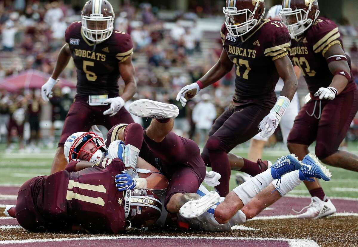 New Caney alum Zion Childress (11) of the Texas State Bobcats recovers a fumble in the end zone by TJ McDaniel (25) of the Southern Methodist Mustangs in the second half at Bobcat Stadium Saturday in San Marcos.