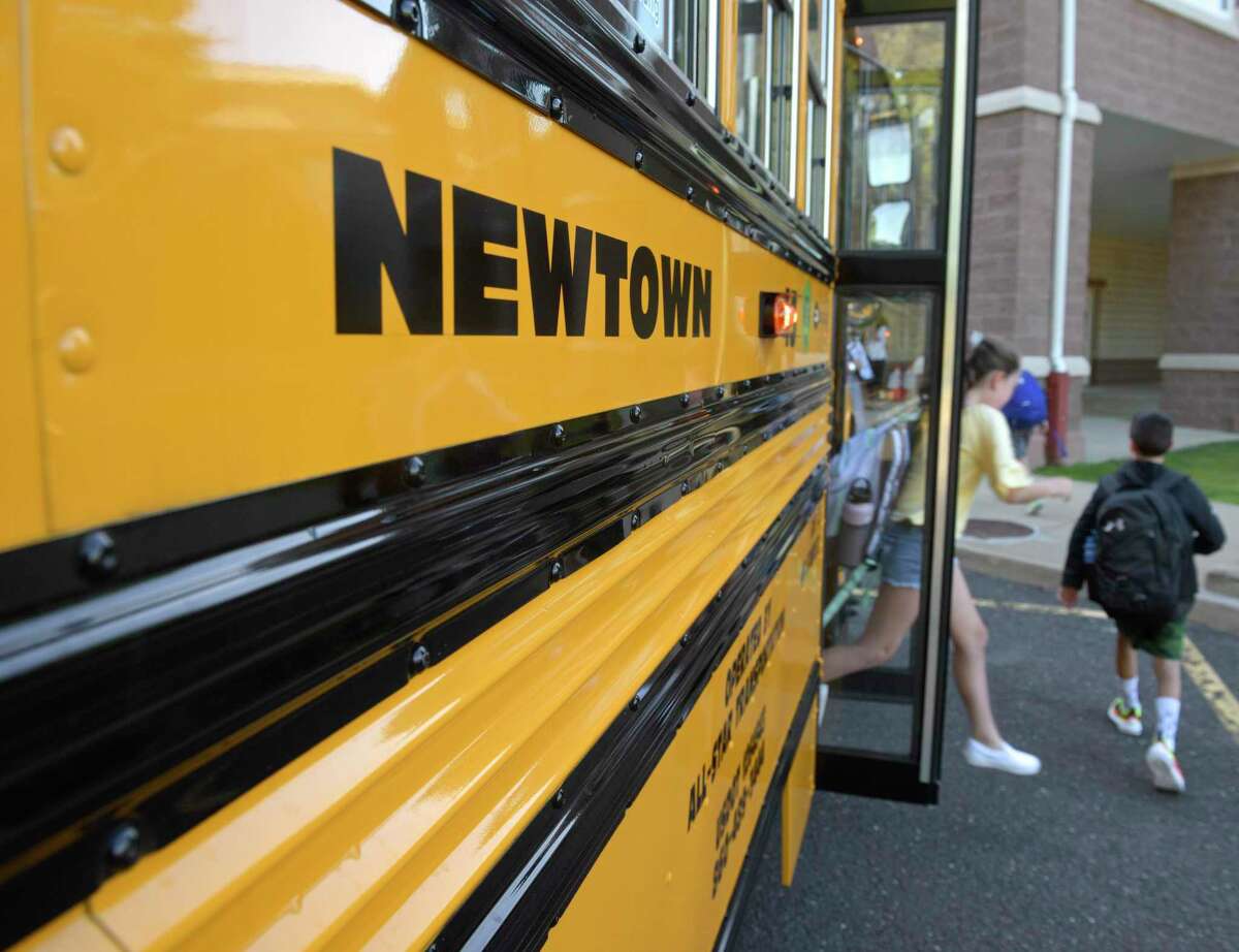Students get off the school bus for their first day of school at Reed Intermediate School. Monday, August 26, 2019, Newtown, Conn.