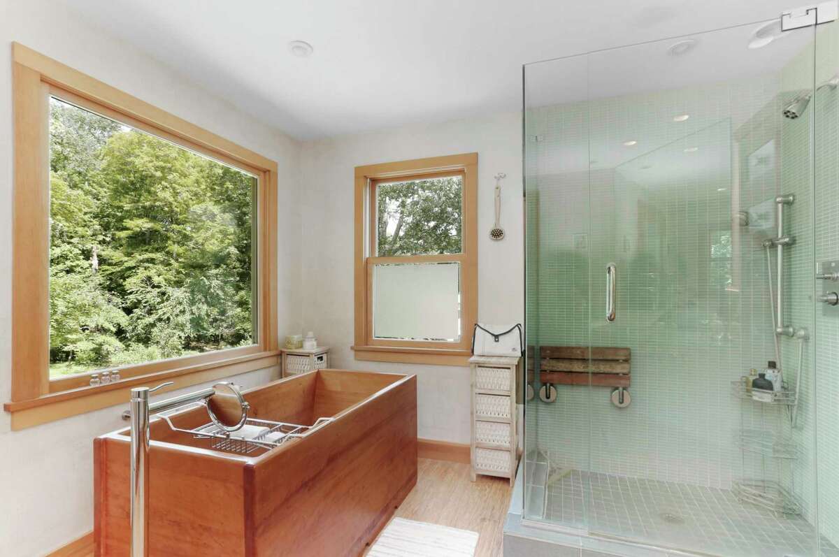 The sophisticated master bath has a Japanese soaking tub, bamboo flooring, glass shower and large picture window looking over the tranquil yard. According to the listing agent, this 2,028-square-foot home