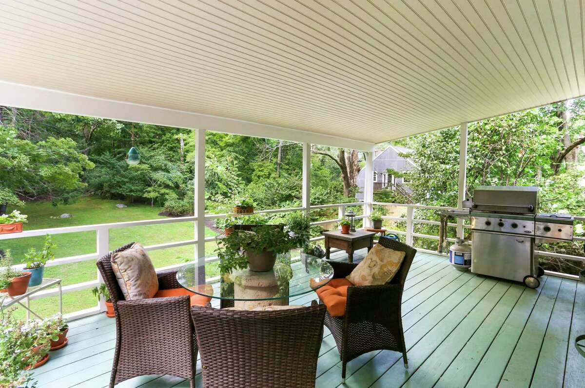 The covered porch looks over the large, private backyard.
