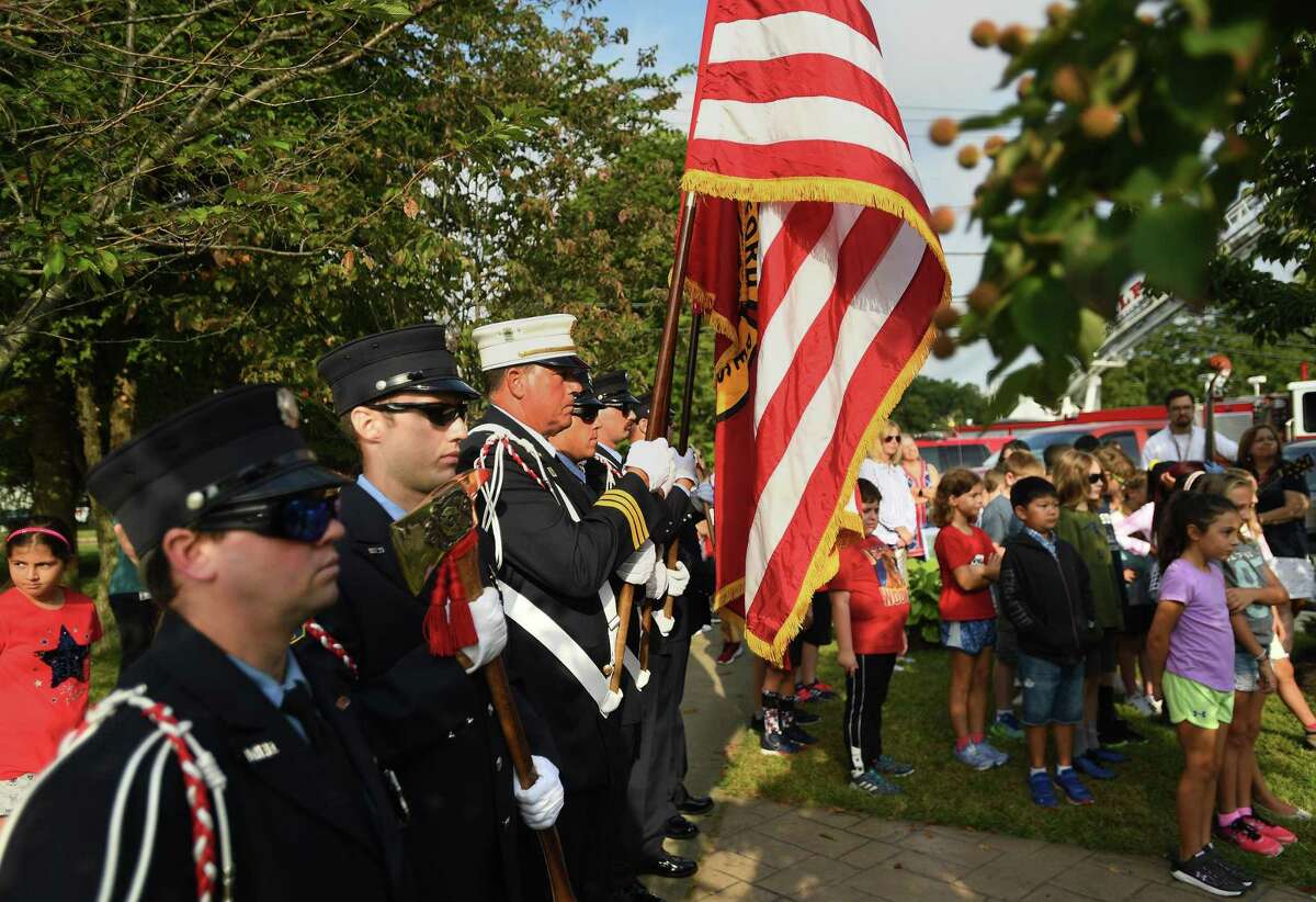The Milford Fire Department Color Guard stands at attention during the annual Milford Remembers 9/11 ceremony at the Live Oaks School Memorial Garden in Milford, Conn. on Wednesday, September 11, 2019.