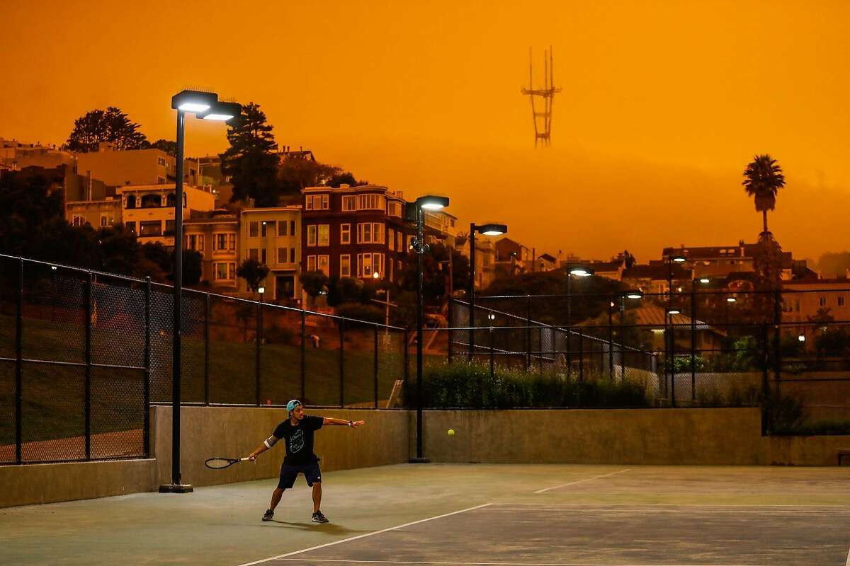 Jonathan Risos plays tennis with a friend at Dolores Park on Wednesday in San Francisco.
