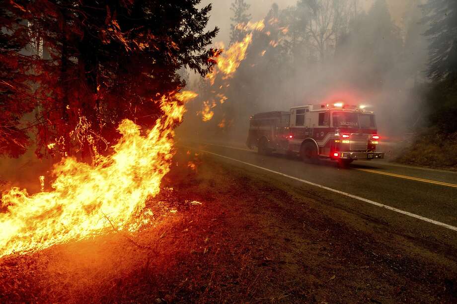 FILE - In this Sept. 7, 2020, file photo a firetruck drives along state Highway 168 while battling the Creek Fire in the Shaver Lake community of Fresno County, Calif. A weekend wildfire east of Fresno exploded so fast that it trapped hundreds of holiday campers who were airlifted to safety in a dramatic rescue that strained the limits of two California National Guard helicopters. (AP Photo/Noah Berger, File) Photo: Noah Berger / Associated Press