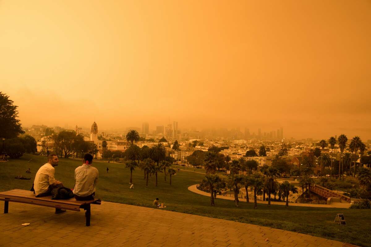 The view of downtown San Francisco from Dolores Park. Smoke from wildfires in California and Oregon spread over San Francisco on Sept. 9, 2020, darkening the skies to an orange hue.