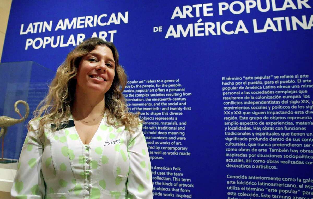 Lucia Abramovich, associate curator of Latin American art at the San Antonio Museum of Art, stands beside the introductory wall of the Latin American Popular Art Gallery.