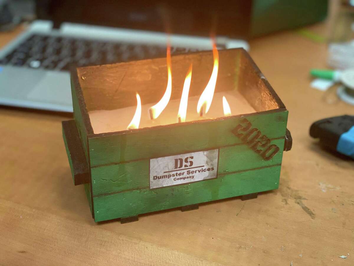 A $30 model dumpster fire by CANopener Labs in San Antonio. CANopener co-founder Drue Placette came up with the design as a nod to NEISD having technical issues during its first day of classes; it soon became a must-have novelty item as a symbol of 2020.