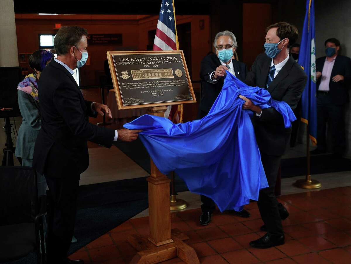 From left, Gov. Ned Lamont, DOT Commissioner Joseph Giulietti and New Haven Mayor Justin Elicker unveil a plaque commemorating the 100th anniversary of Union Station in New Haven, Conn., on Thursday, Sept. 10, 2020.