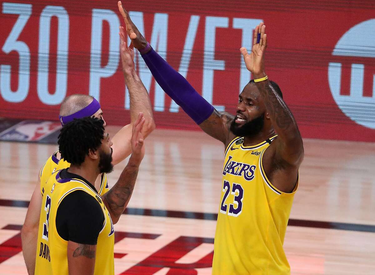 LAKE BUENA VISTA, FLORIDA - SEPTEMBER 10: LeBron James #23 of the Los Angeles Lakers reacts with Anthony Davis #3 of the Los Angeles Lakers during the fourth quarter against the Houston Rockets in Game Four of the Western Conference Second Round during the 2020 NBA Playoffs at AdventHealth Arena at the ESPN Wide World Of Sports Complex on September 10, 2020 in Lake Buena Vista, Florida. NOTE TO USER: User expressly acknowledges and agrees that, by downloading and or using this photograph, User is consenting to the terms and conditions of the Getty Images License Agreement. (Photo by Michael Reaves/Getty Images)