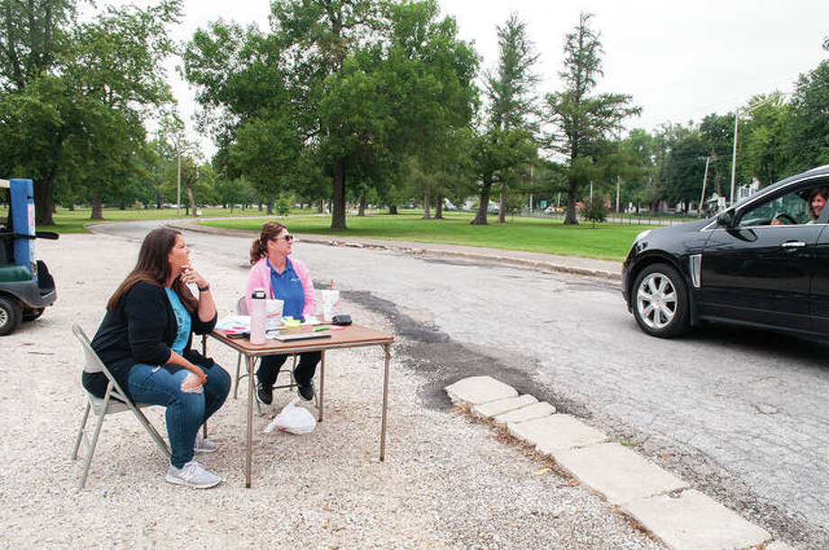 Rachel McGuire (from left) and Bev Allen talk Thursday with Karen Walker during the Jacksonville Area Chamber of Commerce’s steak fry at Community Park. In past years, the event was held at the Jacksonville Airport and included social events and an auction. Because of pandemic restrictions, the chamber made the event drive-through service. Photo: Darren Iozia | Journal-Courier