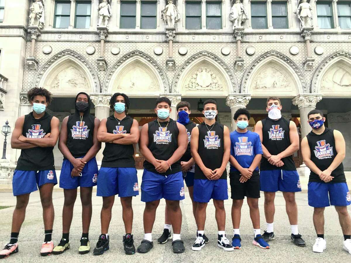 Members of the Danbury High School football team participated in a rally for a football season a the state Capitol on Wednesday, Sept. 9, 2020. Third from left is Brenyn Boswell, who said, “I wish they would at least give us a definite ‘No.’”