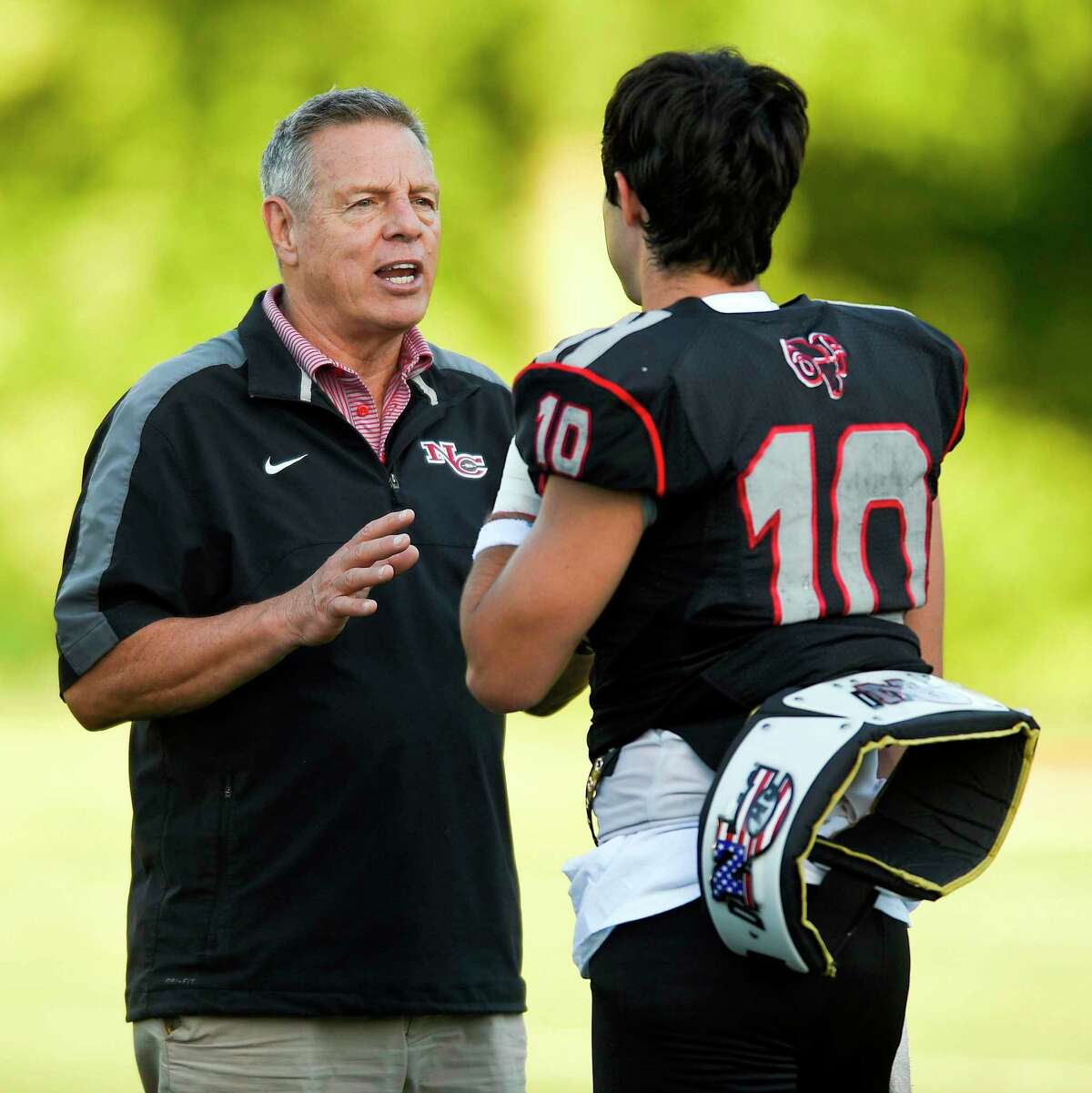 New Canaan coach Lou Marinelli chats with quarterback Drew Pyne during the 11th Annual Brian Wilderman Memorial Red and White football game at Dunning Stadium in New Canaan on June 15, 2018.