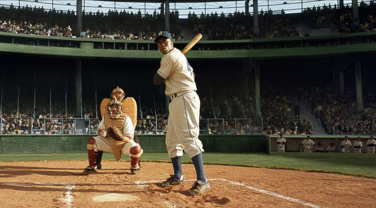 This publicity film image released by Warner Bros. Pictures shows Chadwick Boseman, right, as Jackie Robinson in Warner Bros. Pictures’ and Legendary Pictures’ drama “42,” a Warner Bros. Pictures release.