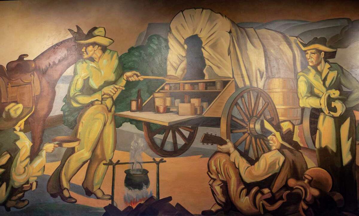 A section of “The History of Ranching,” a mural commissioned by the Pearl Brewery in 1950, depicts cowboys gathered around a chuckwagon. Three restored sections of the mural have been installed over the reference desk on the first floor of the Albert B. Alkek Library at Texas State University in San Marcos.