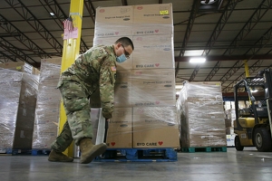 A Texas National Guard personnel works with boxes of Personal Protective Equipment as Texas Gov. Greg Abbott along with state officials visit a Texas Division of Emergency Management Warehouse located within the city on Aug. 4. Abbott toured the facility which is one of 40 warehouses in the state that stores and distributes the PPE equipment. Units of Texas National Guard are deployed throughout the state to help with the Coronavirus pandemic.