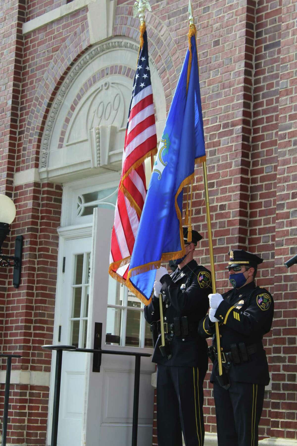 New Canaan Police present the colors on the steps of Town Hall Friday as New Canaan pauses to mark the 19th anniversary of the terrorist attacks of Sept. 11, 2001.