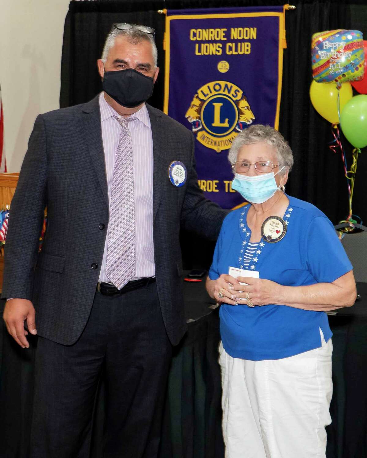 Last Wednesday Conroe Noon Lions Club President Ralph Perez, left, congratulates Lion Ladoris Cates on 25 years of perfect attendance.