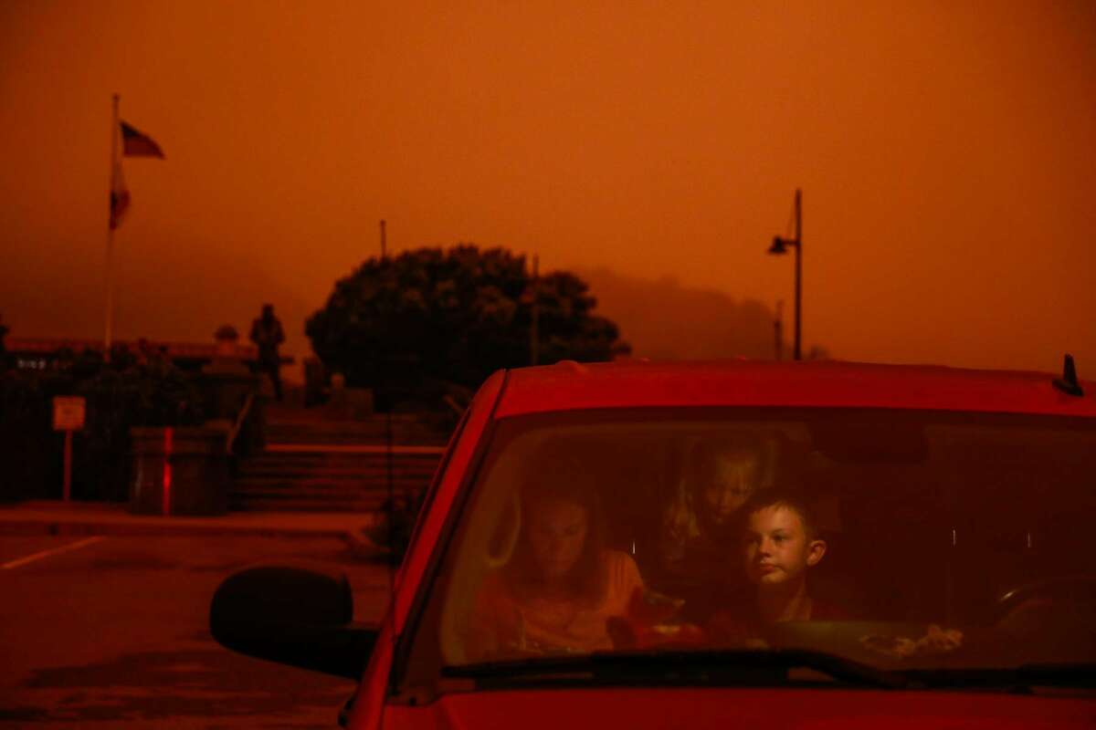 Lisa Trythall, of Salt Lake City, makes sandwiches for her children including son Luke Trythall (right) as they sit in their car during a road trip in Sausalito, Calif. Wednesday, September 9, 2020. The sky was orange and smoky due to multiple wildfires burning across California and Oregon.